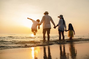 A family having fun on the beach at sunset