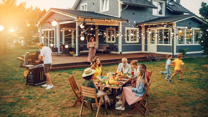 A family having a barbecue in their backyard.