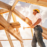 A male construction worker building a new home.