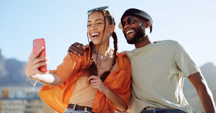 A young couple smiling while on vacation.