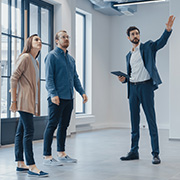 A man showcasing an empty building to prospective clients.