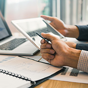 A group of people reviewing finances on a laptop.