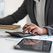 A man calculating finances at a laptop.