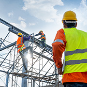 Construction workers building the frame of a house.