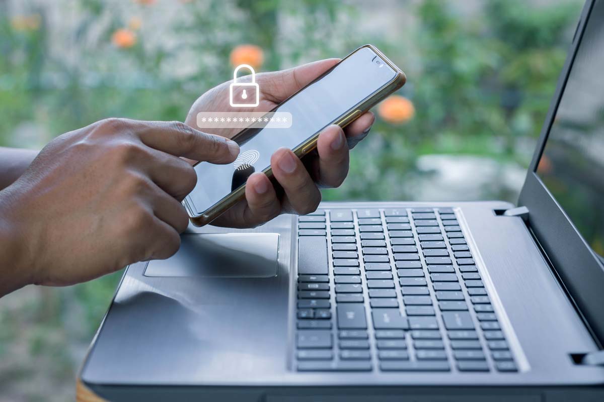 A person securing their phone and laptop.