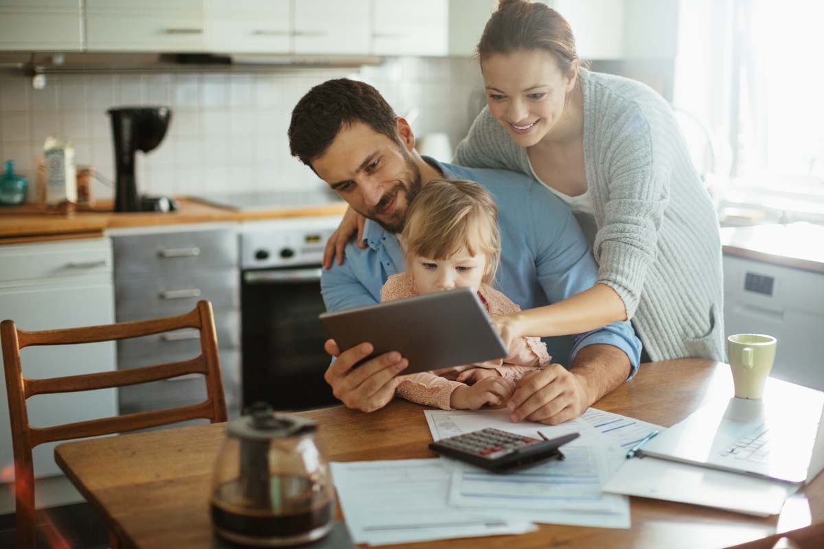 A family reviewing finances at the dinner table.