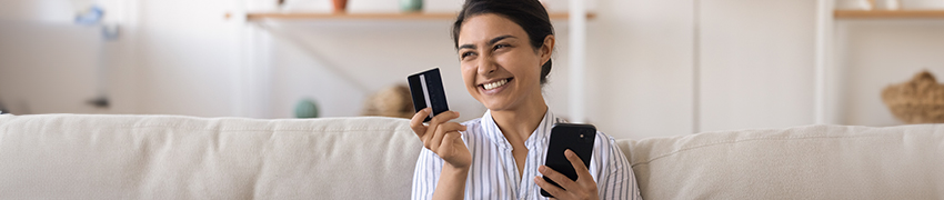 A woman on their laptop using their credit card